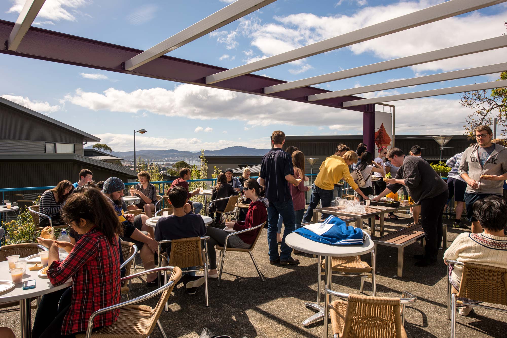 Students eating outside at Sandy Bay accommodation