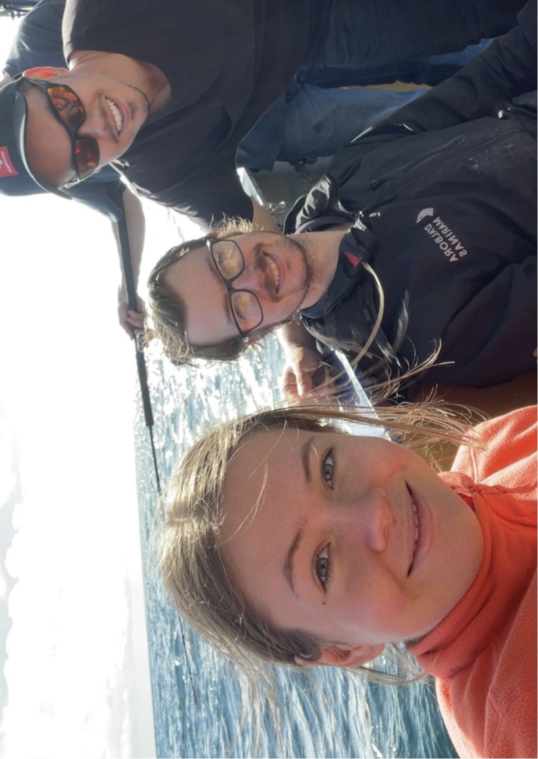 Maritime Engineering students (left to right) Cameron Skeggs, Tom Dewhurst, and Tyler Ratcliff on the deck of a research vessel on the water.